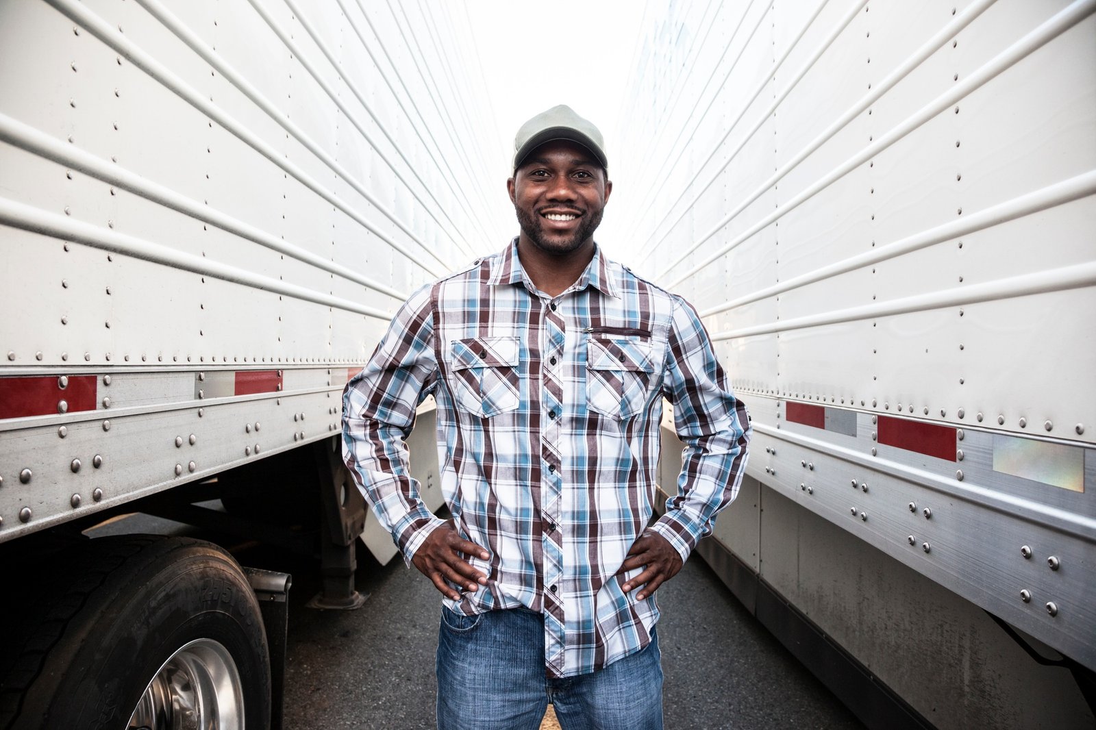 Trucker standing by his large truck